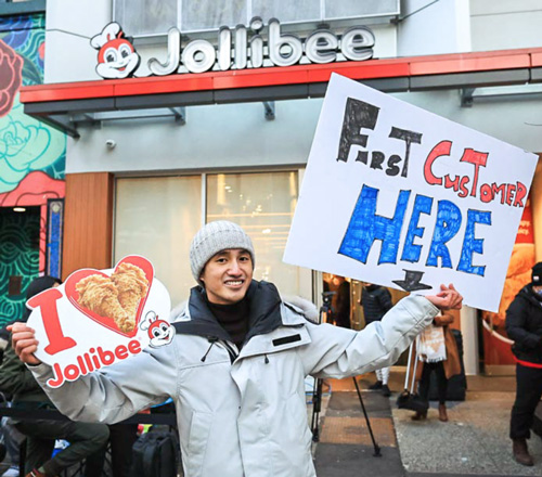 Vancouver resident Kei Kondo camped out at 833 Granville Street for over 12 hours to be Jollibee’s first official customer on opening day. (Photo credit: Jollibee Canada)