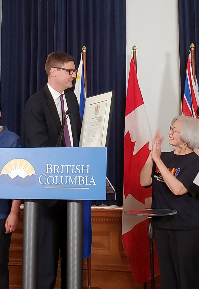 B.C. Attorney General David Eby presents a copy of the Filipino Heritage Month declaration to the Bayanihan Cultural and Housing Society. Photo by Sid Emmanuel and Ligaya Sukke.