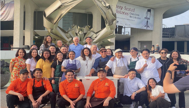 Chef TJ Conwi (centre, in dark glasses) and Maj Yee (second from left, standing) with the other Filipino chefs who participated in a fundraiser for Lapu-Lapu survivors and familie