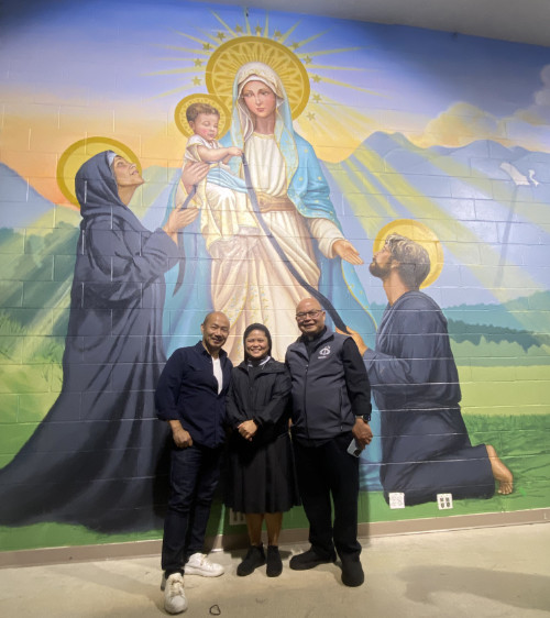 Artist Leo Cunanan Jr. with Sr. Izah C. Aldover and Fr. Mark Bautista in front of Cunanan’s work.